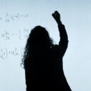 Woman writing on board