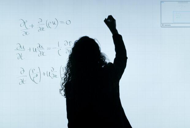 Woman writing on board