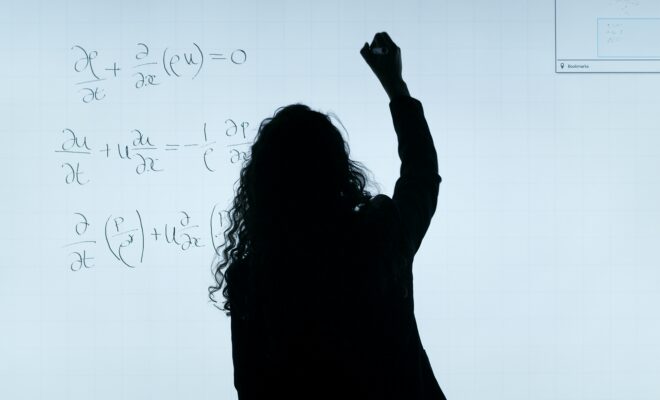 Woman writing on board